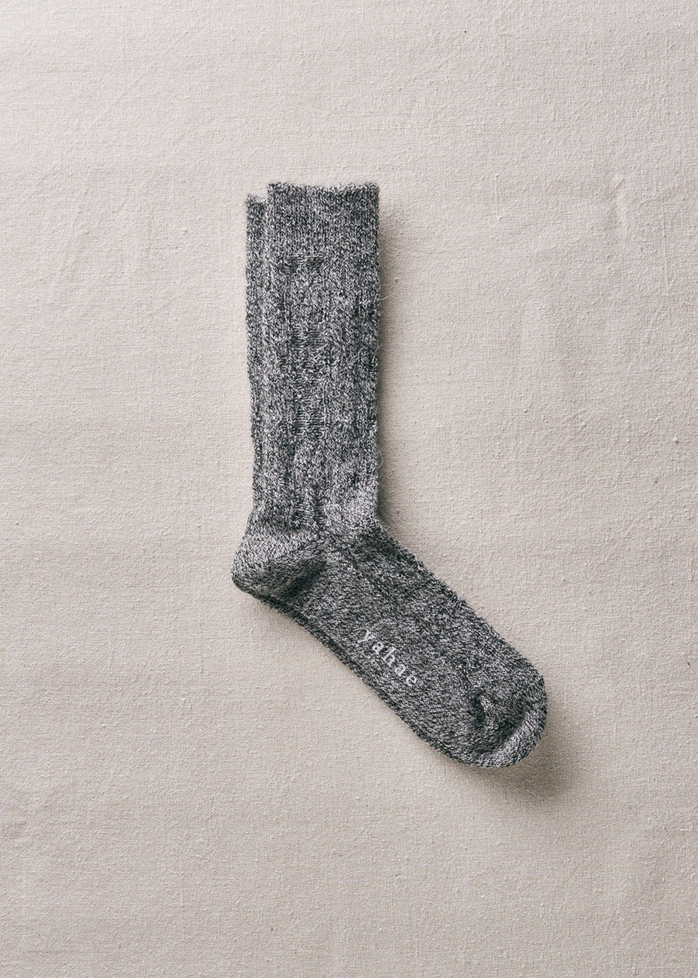 Gray sock on a beige background