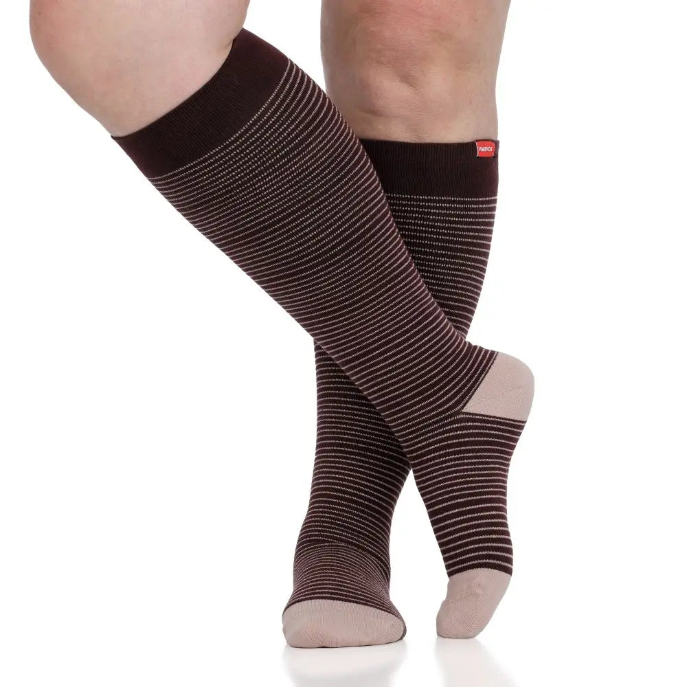 Brown striped knee-high compression socks worn by a person on a white background