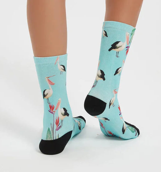 Light blue socks with bird pattern worn by a person on a white background
