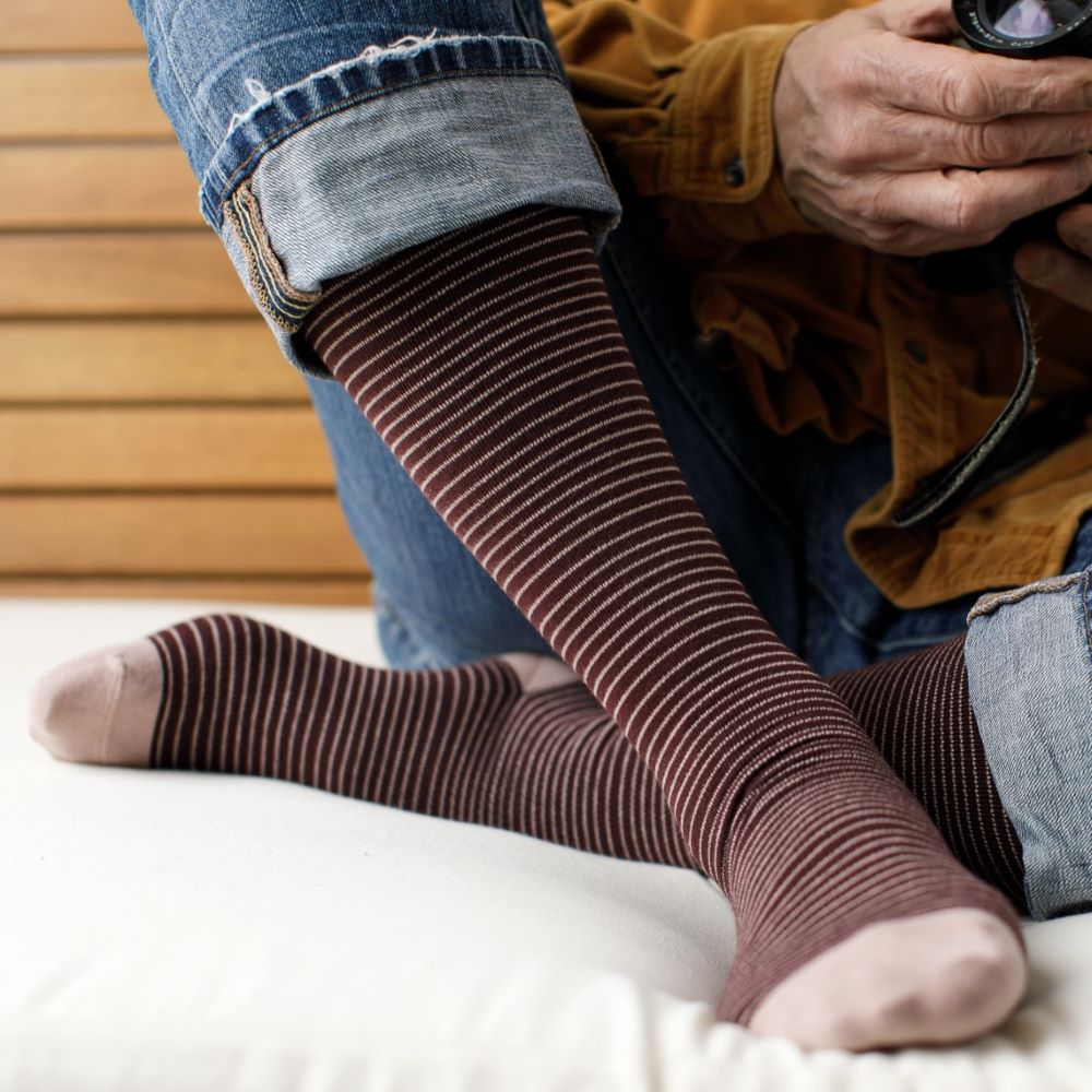 Person wearing brown striped compressionvsocks with a blurred background