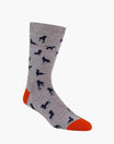 Gray sock with black dog patterns and orange toes on a white background
