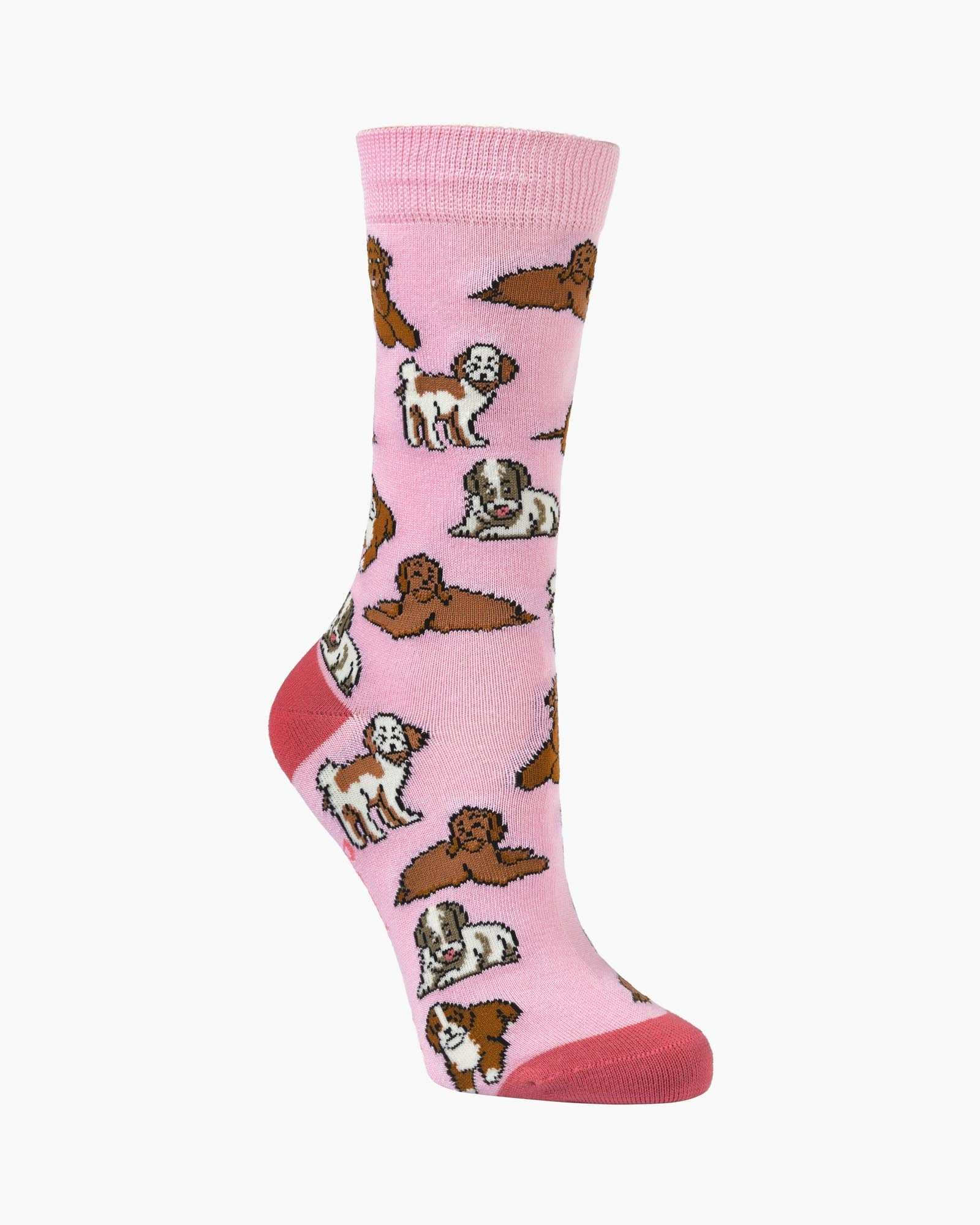 A single pink crew sock with an all-over pattern of different dog breeds in brown, white, and black, shown on a plain light gray background.