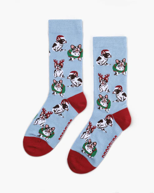 Two light blue socks with dog illustrations and red toes on a white background