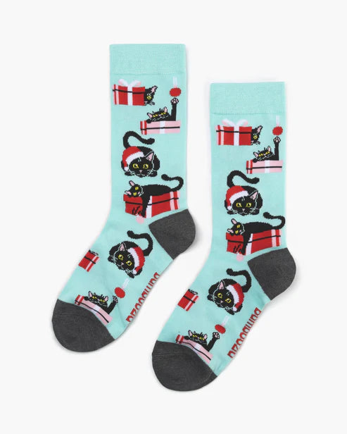 Two socks with black cat and gift design on a light blue background