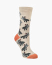Beige sock with dog pattern and orange toes on a white background