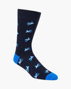A single crew sock in dark navy blue with a repeating pattern of light blue and white airplanes, finished with bright blue toe and heel accents, shown on a plain light gray background.
