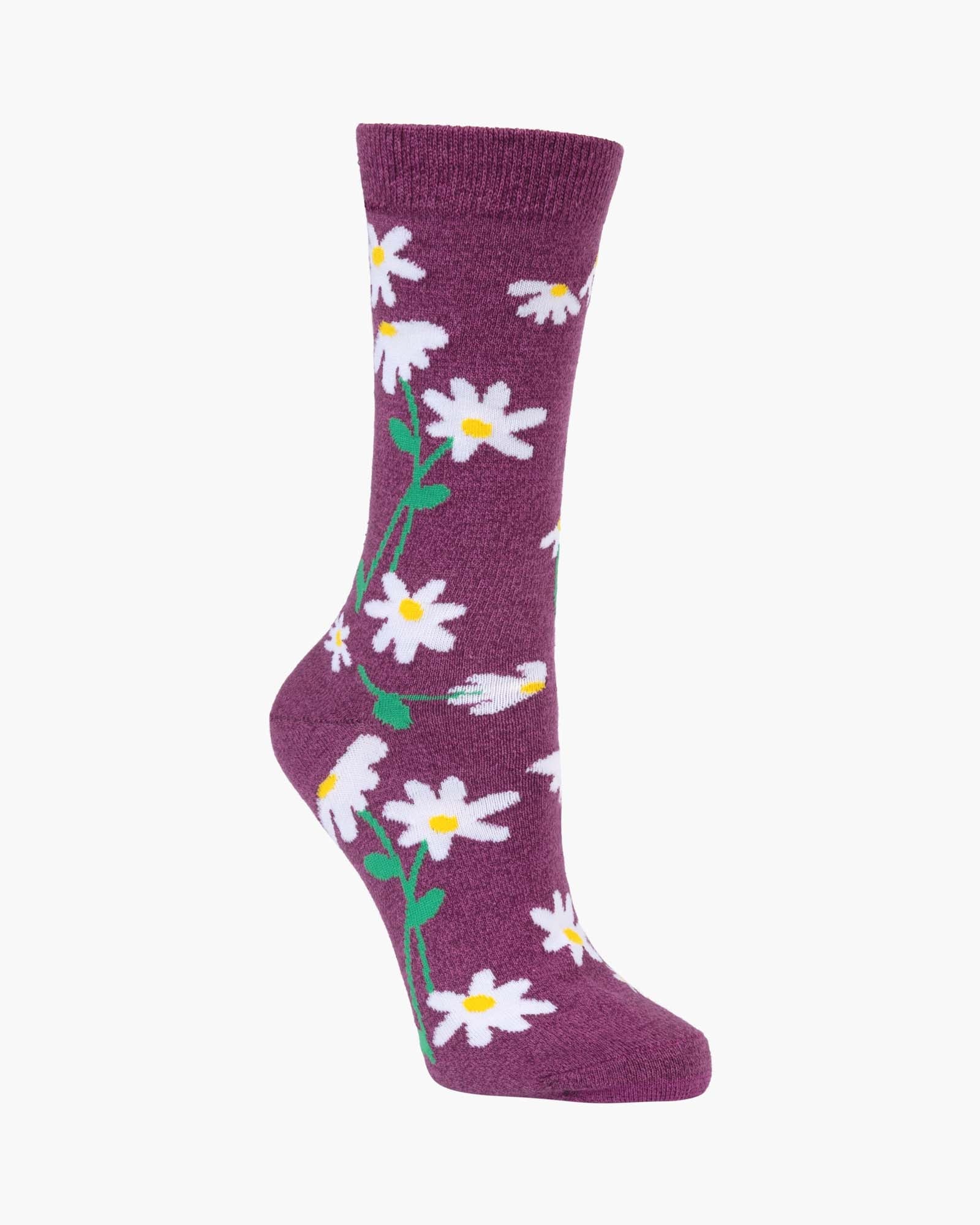 A single crew sock in a deep plum purple color, decorated with a repeating pattern of white daisies with yellow centers and green stems, shown against a plain off-white background.