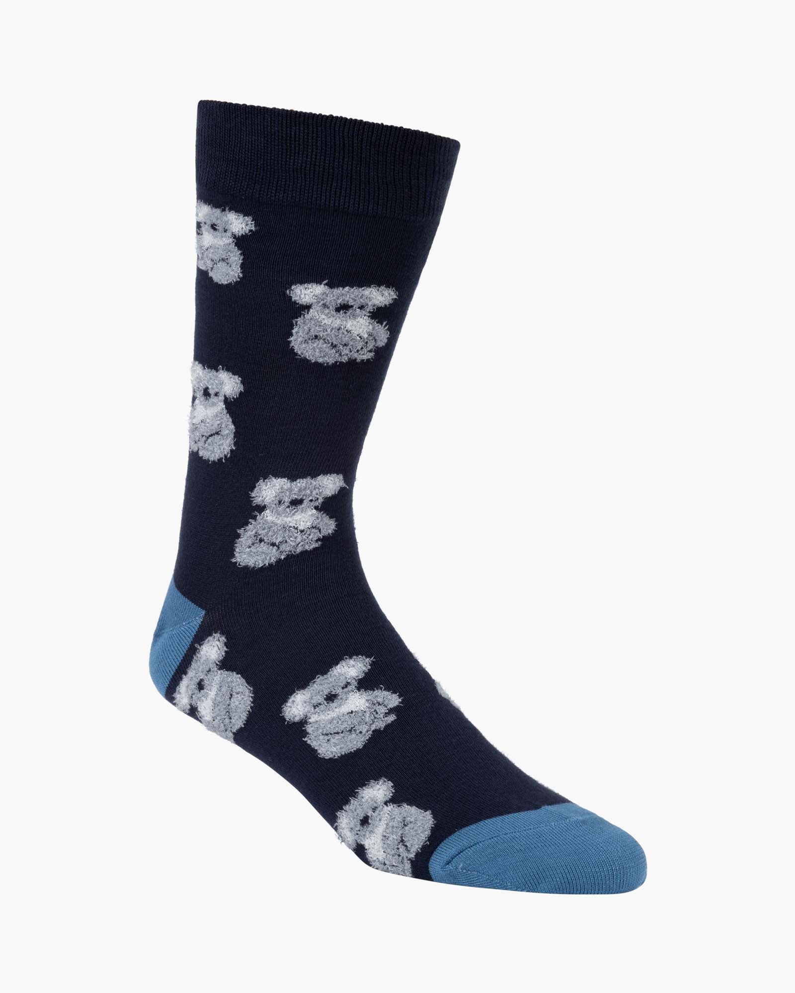 Navy sock with a fluffy koala pattern and blue toes on a white background