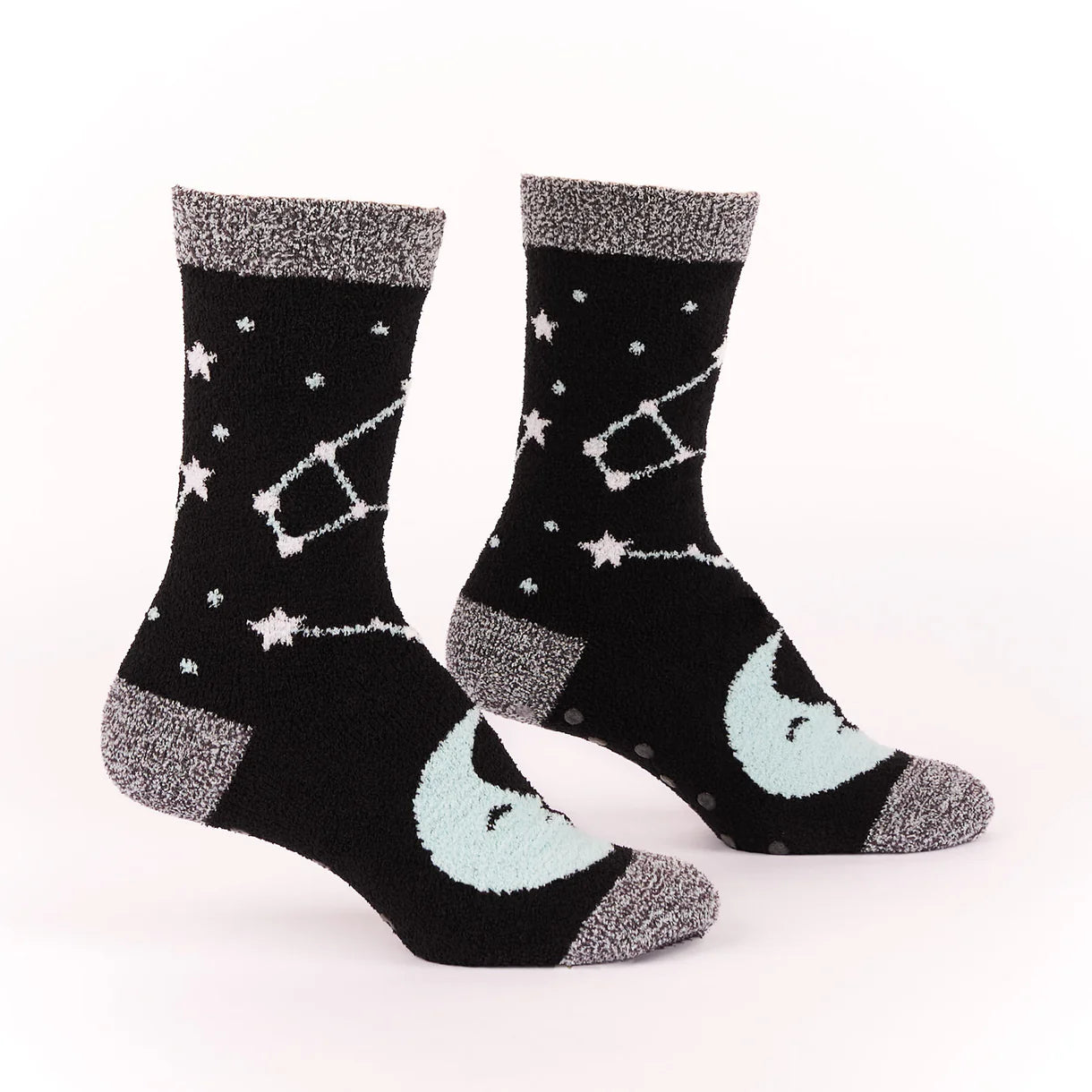 Black socks with star and constellation patterns on a white background