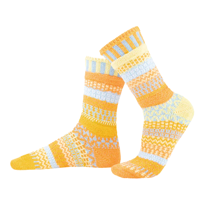 Pair of yellow and white patterned socks on a white background