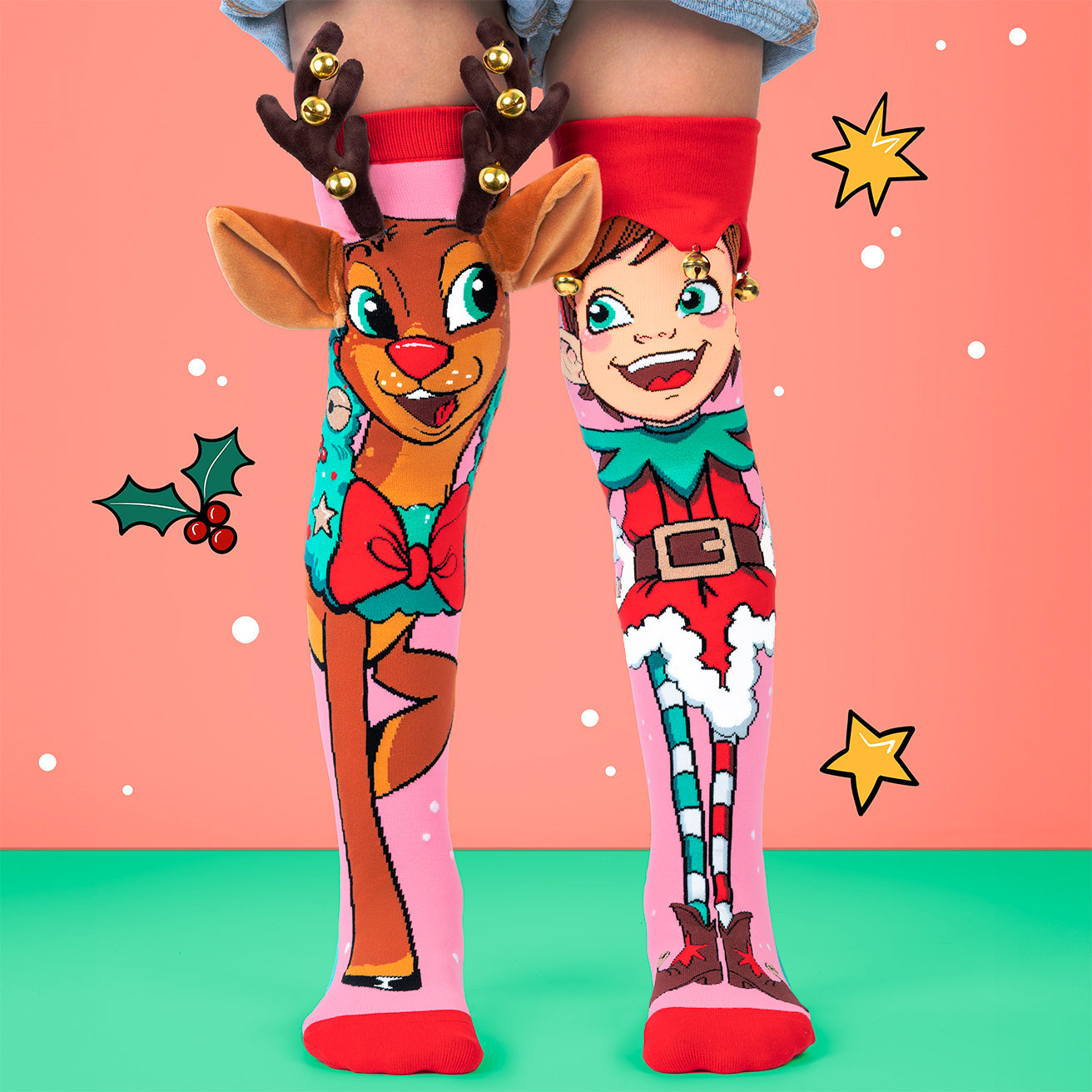 Colorful Christmas-themed socks with reindeer and elf designs on a pink and green background.