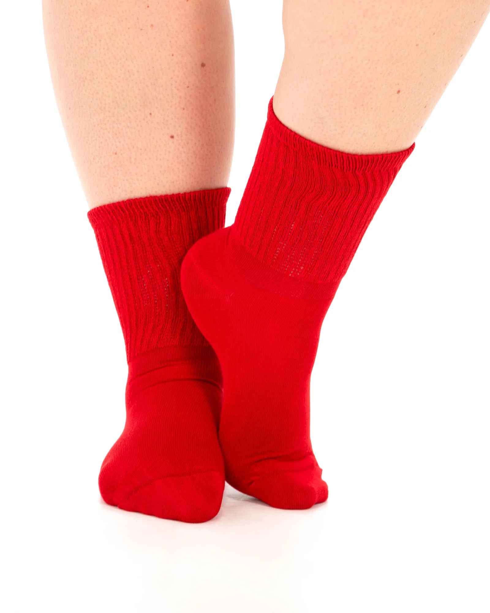 Red socks worn on a white background