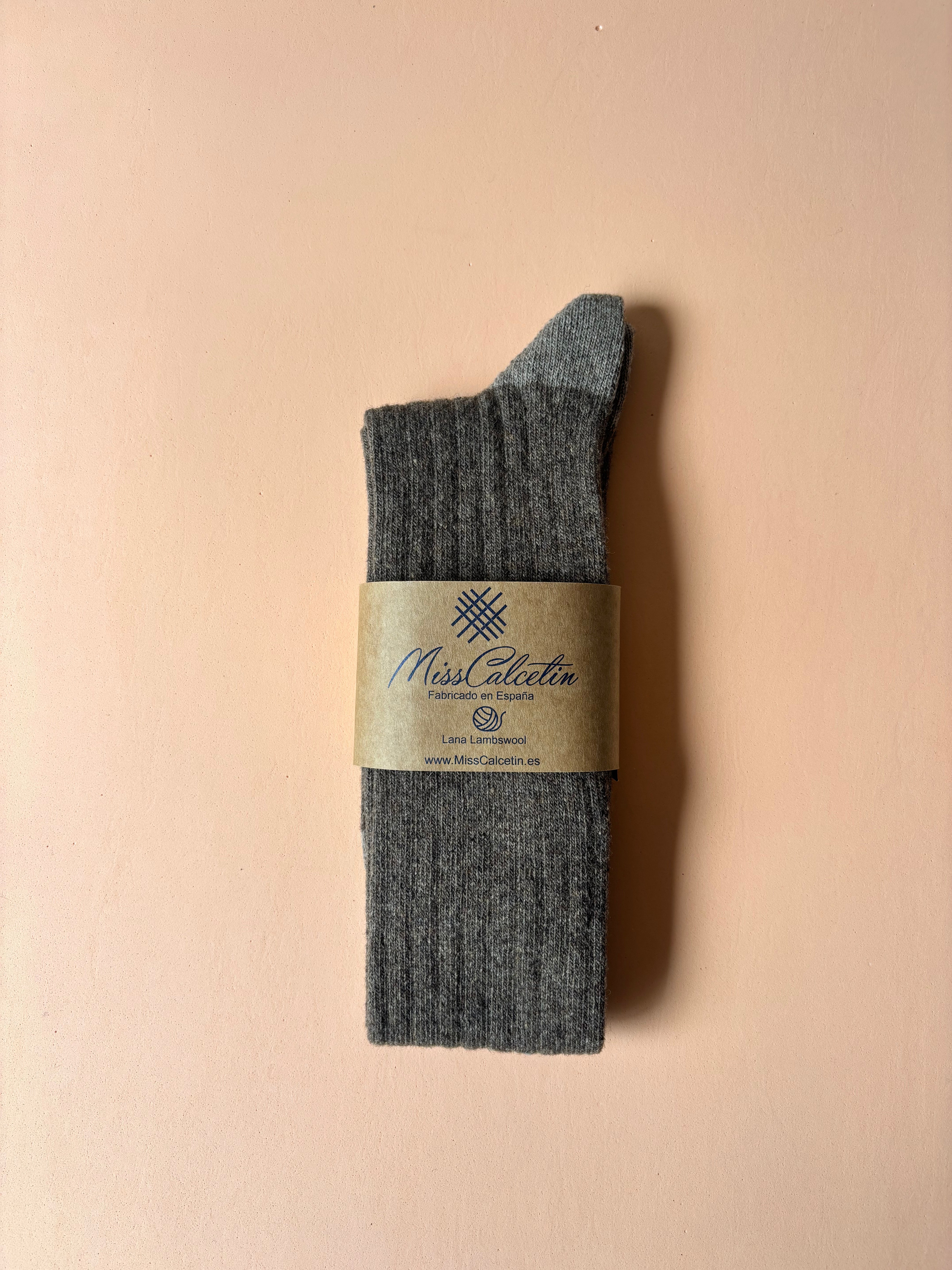Gray sock with a label on a beige background