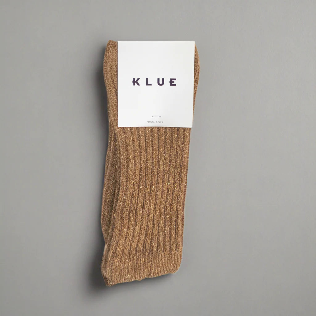 Brown sock with a KLUE label on a gray background
