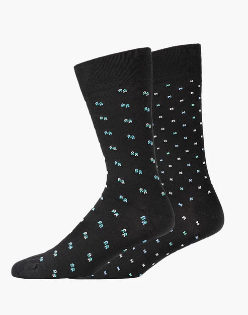 Two black socks with small white and blue patterns on a white background