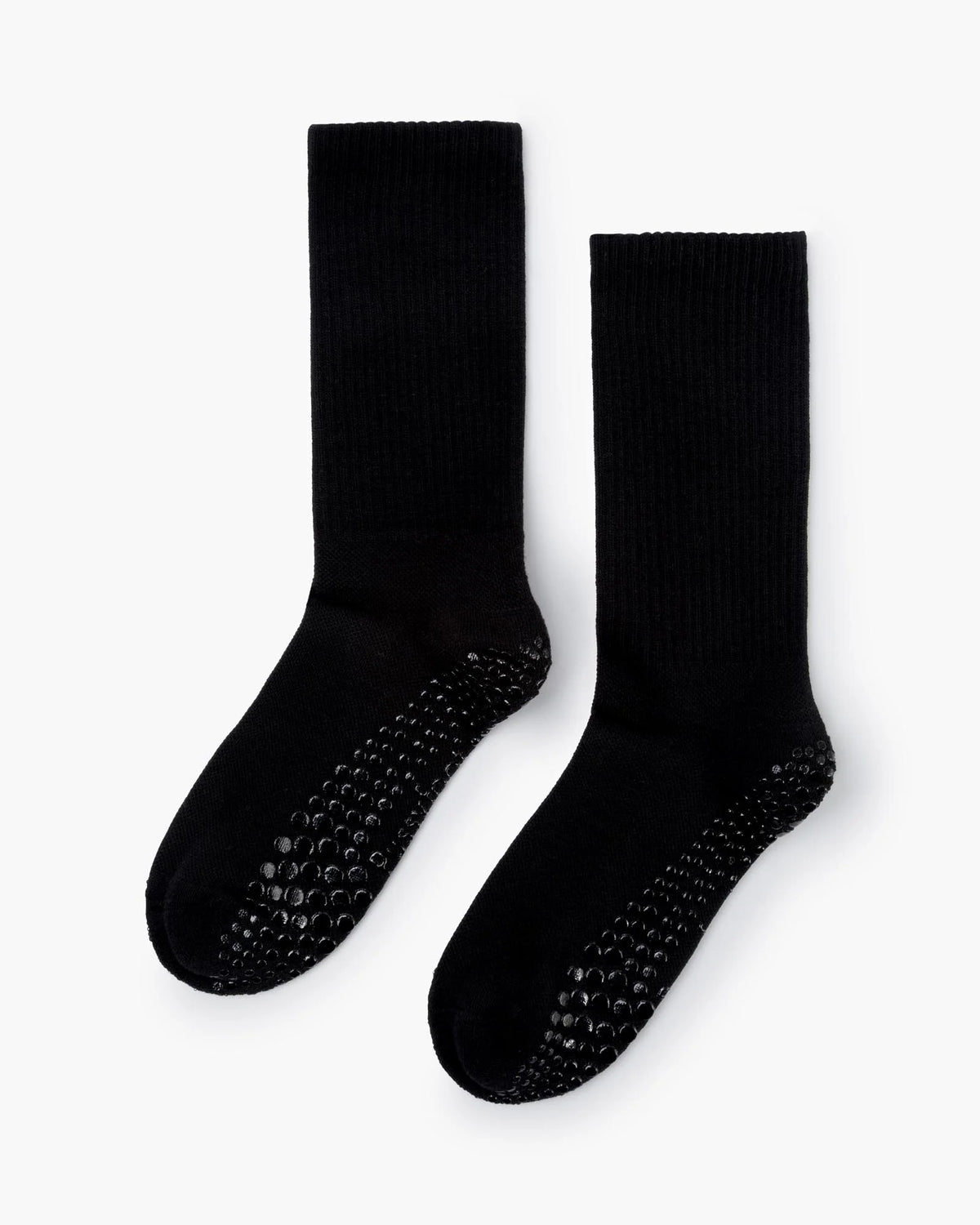 Pair of black socks with textured sole on a white background