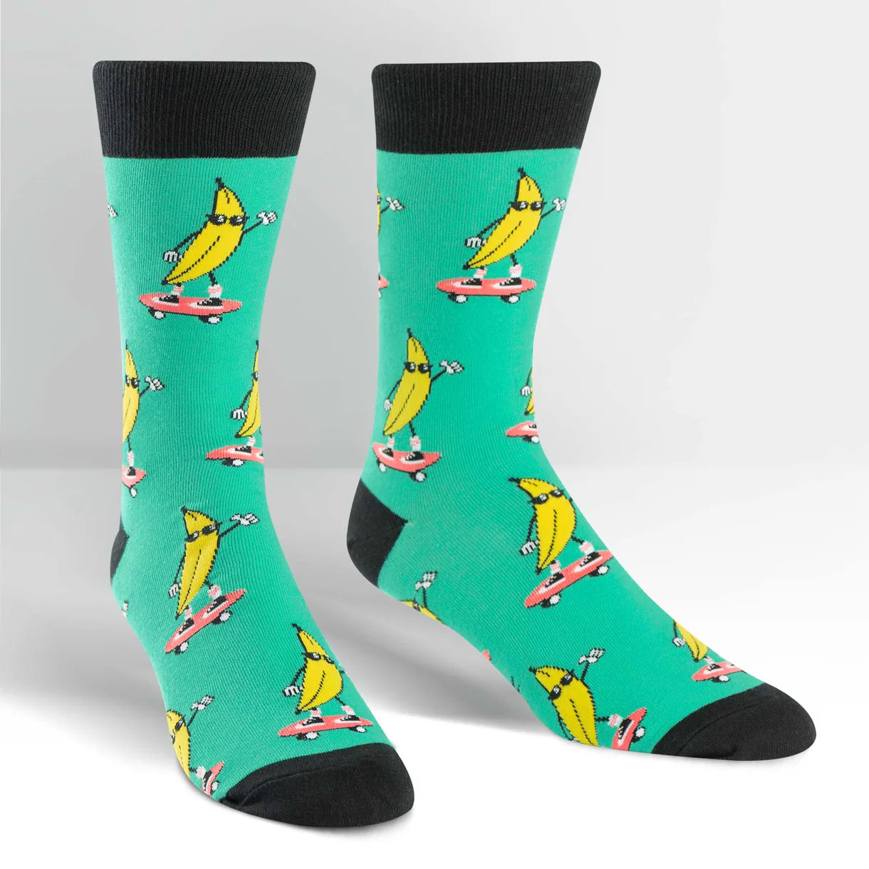 Teal socks with banana characters on a white background