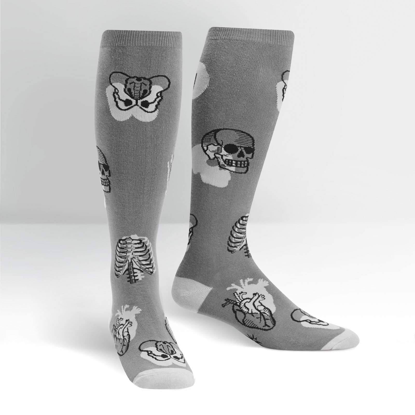 Gray knee-high socks with black and white skull, bone, and anatomical heart designs on a white background.