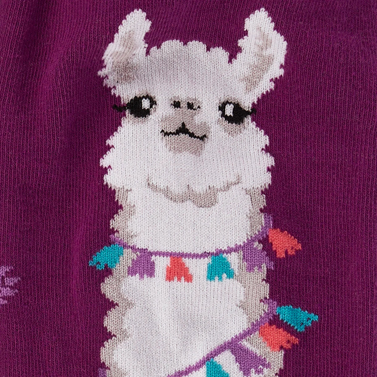 Socks with a llama design on a purple background