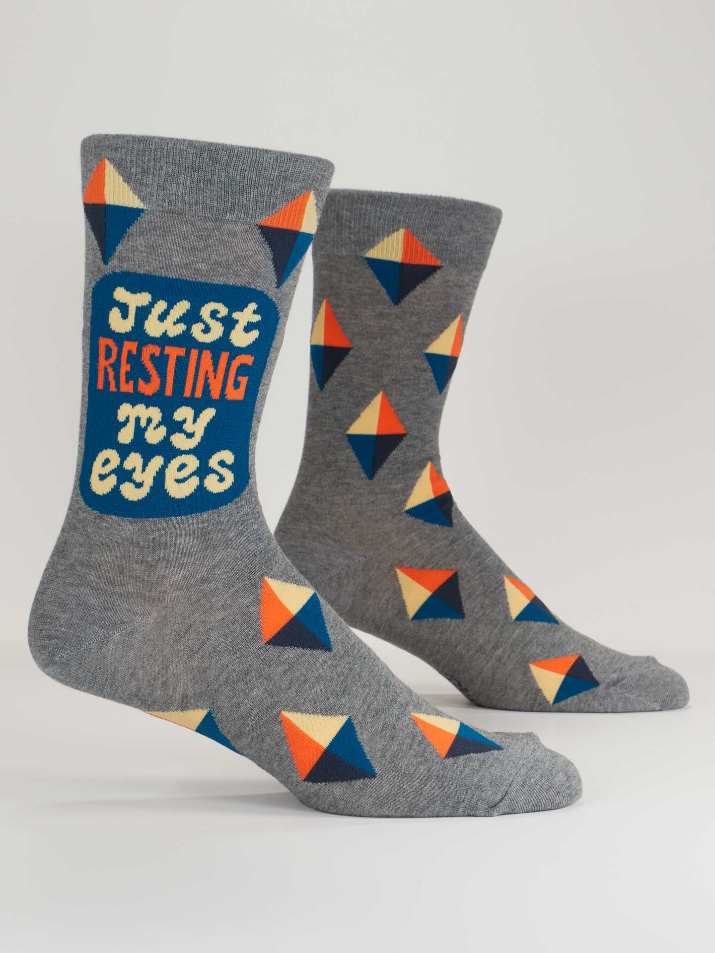 Gray socks with geometric pattern and 'Just Resting My Eyes' text on a white background