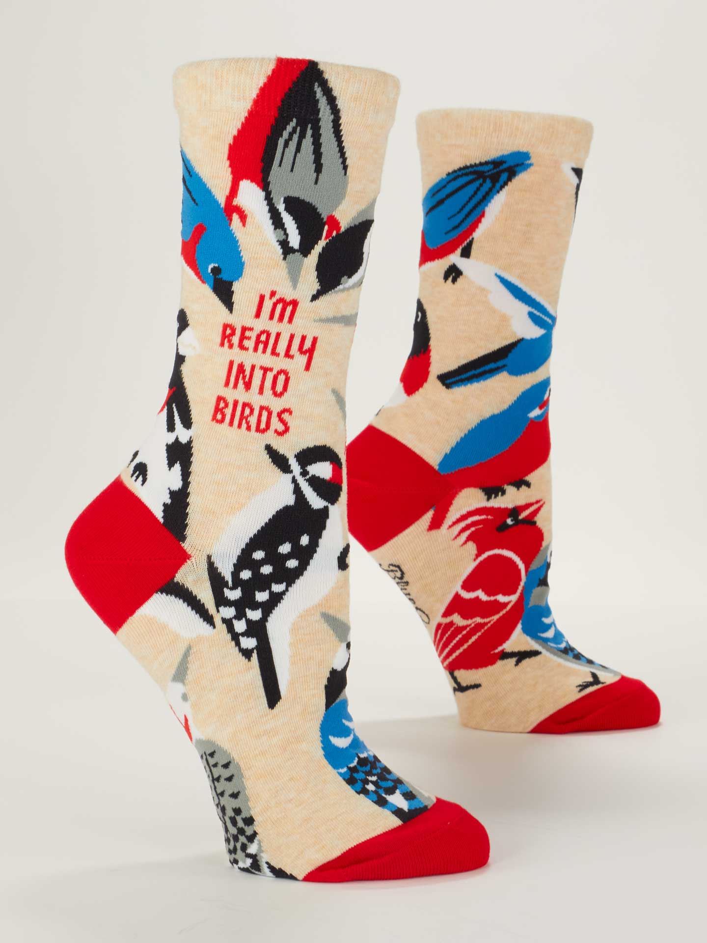 Colorful socks with bird designs and text on a beige background