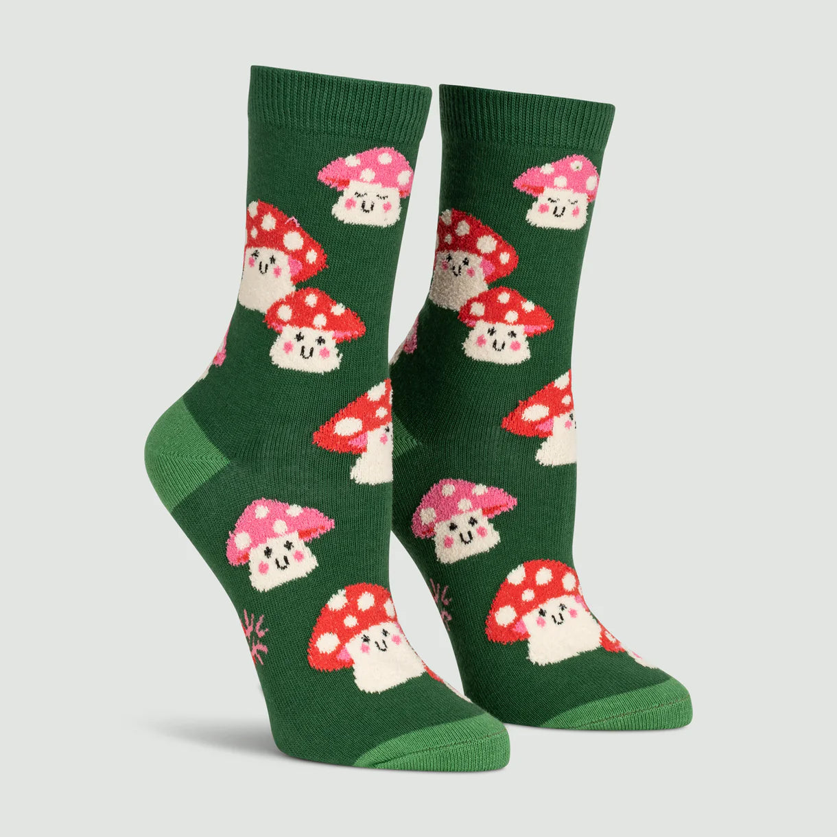 Green socks with mushroom pattern on a light gray background