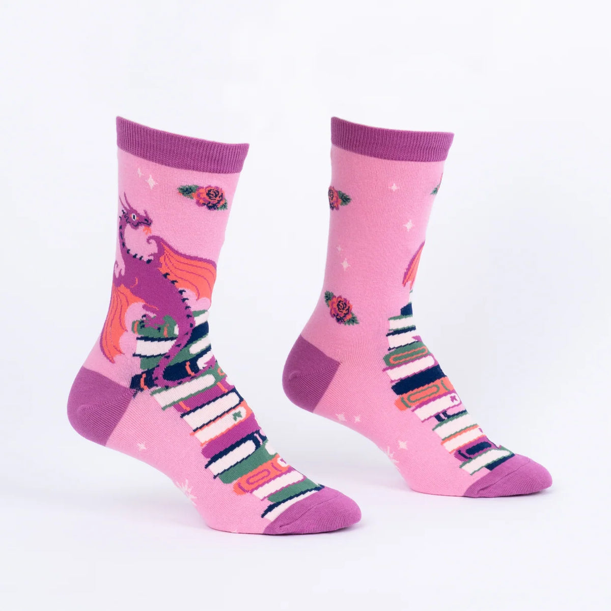 Pink socks with books and dragons on them