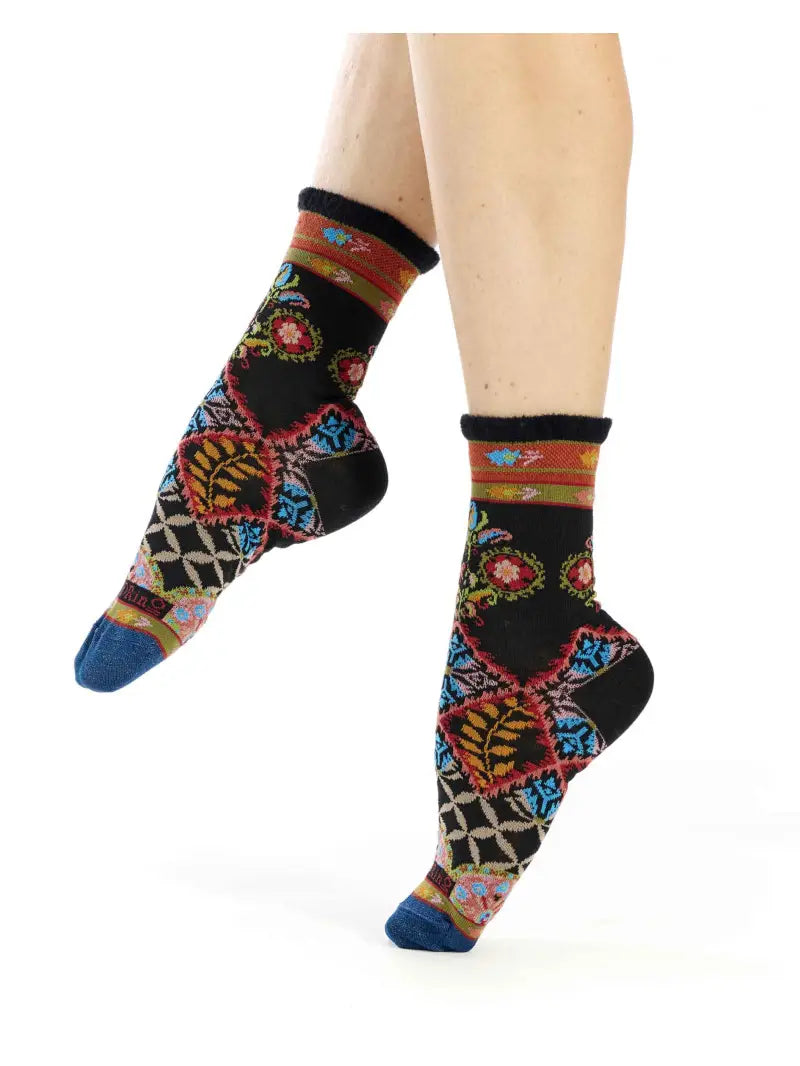 Colorful patterned socks worn on a white background