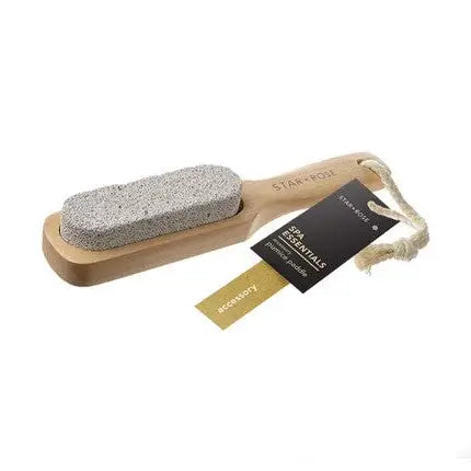 A wooden spa brush with a gray stone bristle head, a black and gold hangtag, and a rope loop, shown on a plain white background.