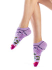 Purple socks with floral patterns worn by a person on a white background