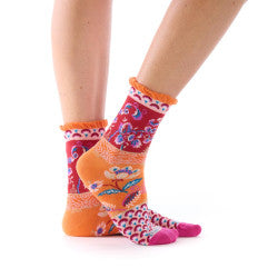 Colorful patterned socks worn by a person on a white background