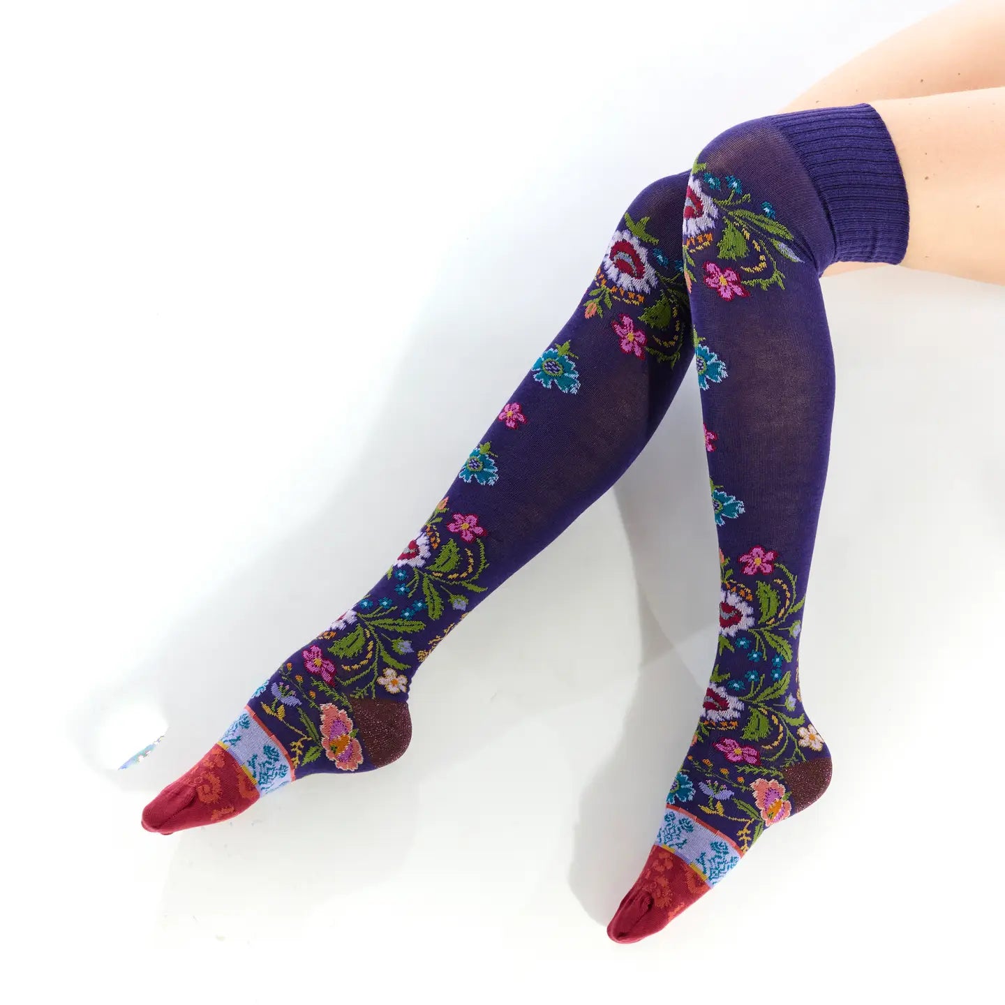 Colorful floral-patterned knee-high socks on a white background