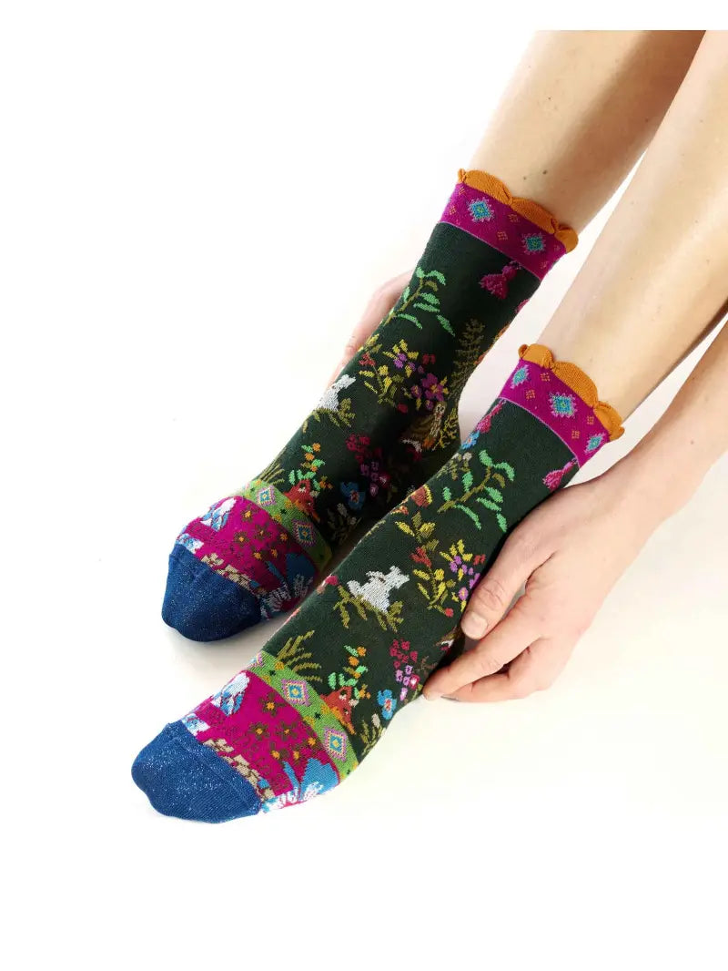 Colorful patterned socks being worn on a white background