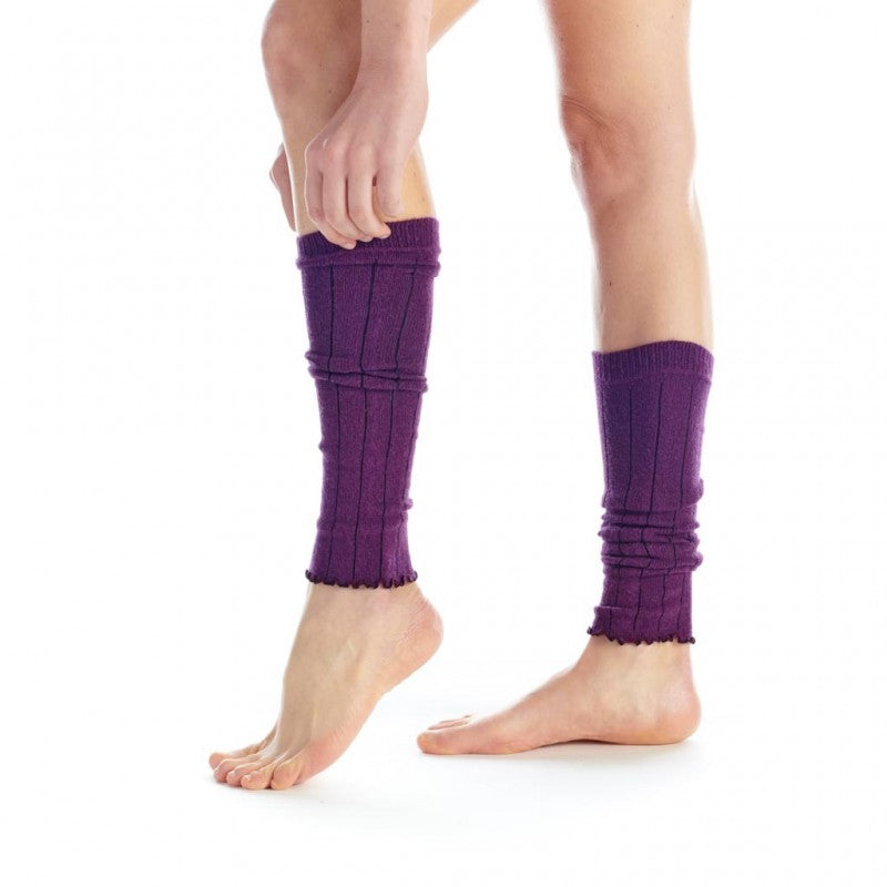 Purple leg warmers worn by a person on a white background