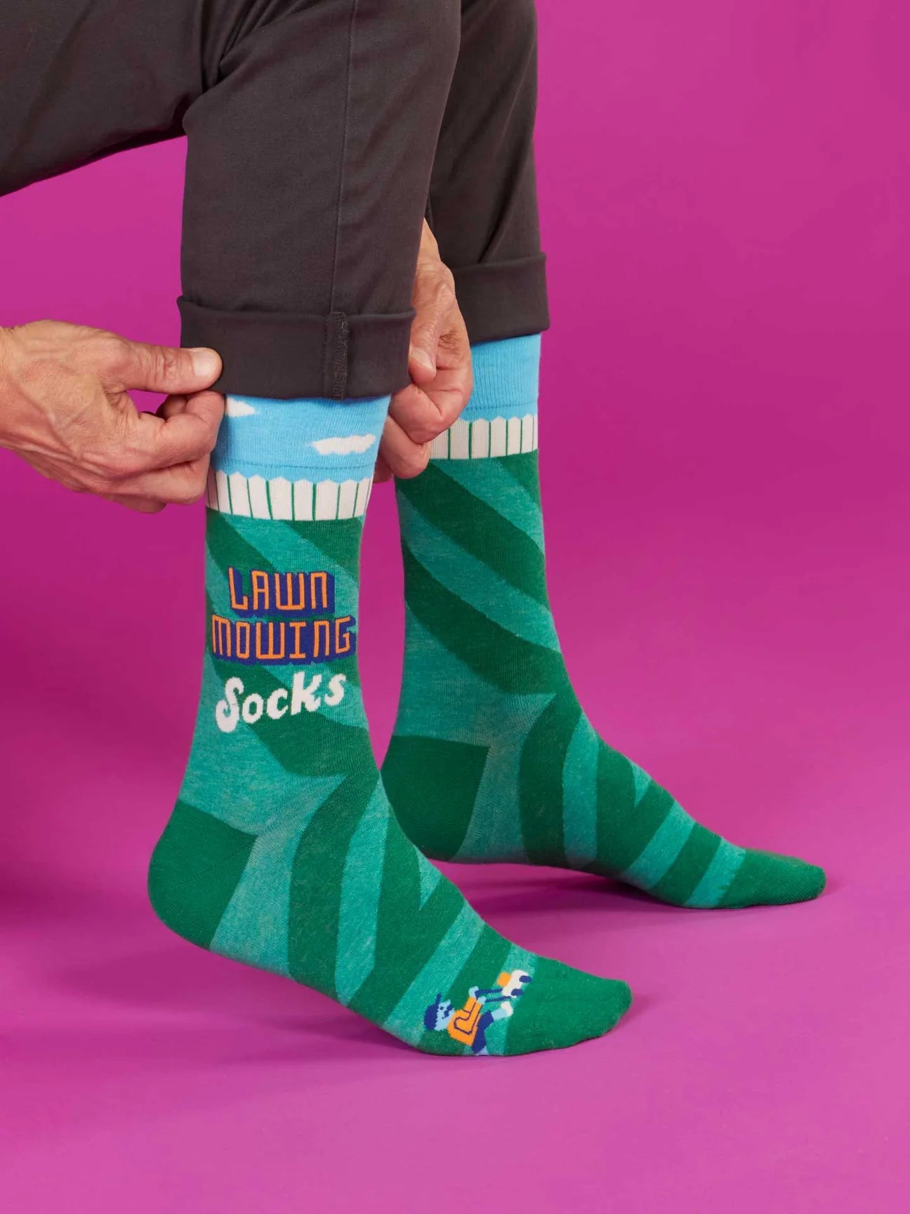 Green and blue socks with 'Lawn Mowing Socks' text on a white background