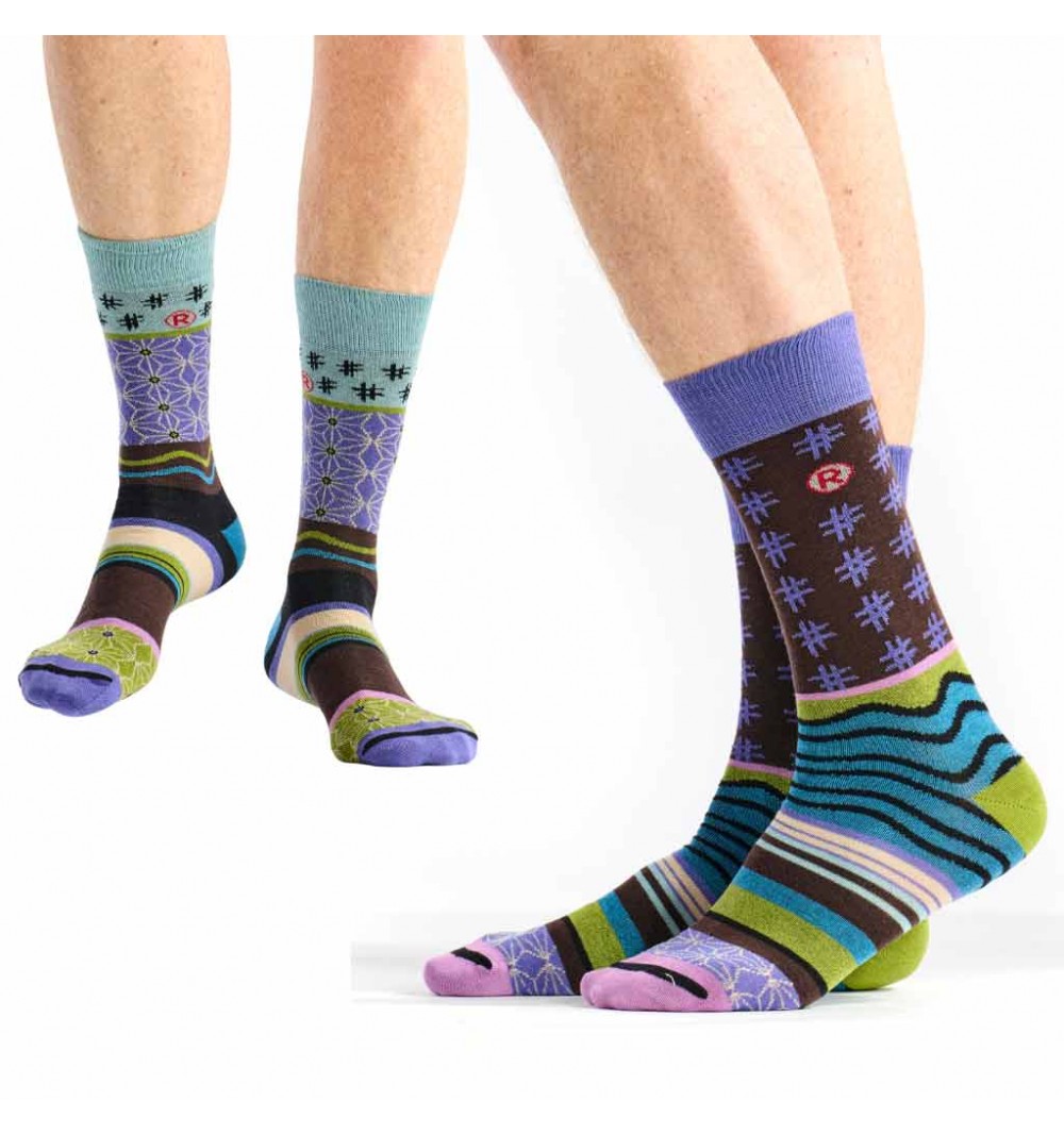Colorful patterned socks worn by a person on a white background