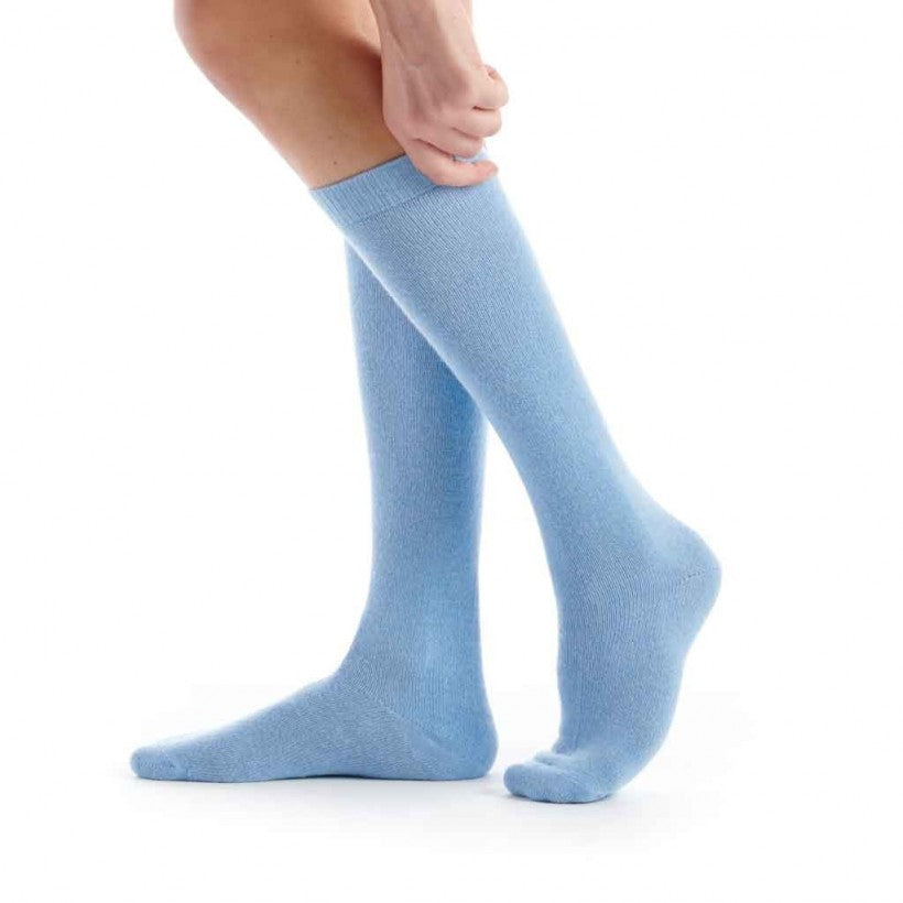 Light blue knee-high socks worn by a person on a white background