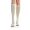 Beige knee-high socks worn by a person on a white background