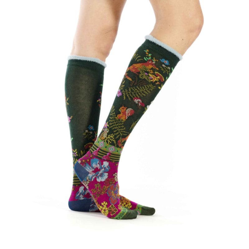 Colorful patterned socks worn by a person on a white background