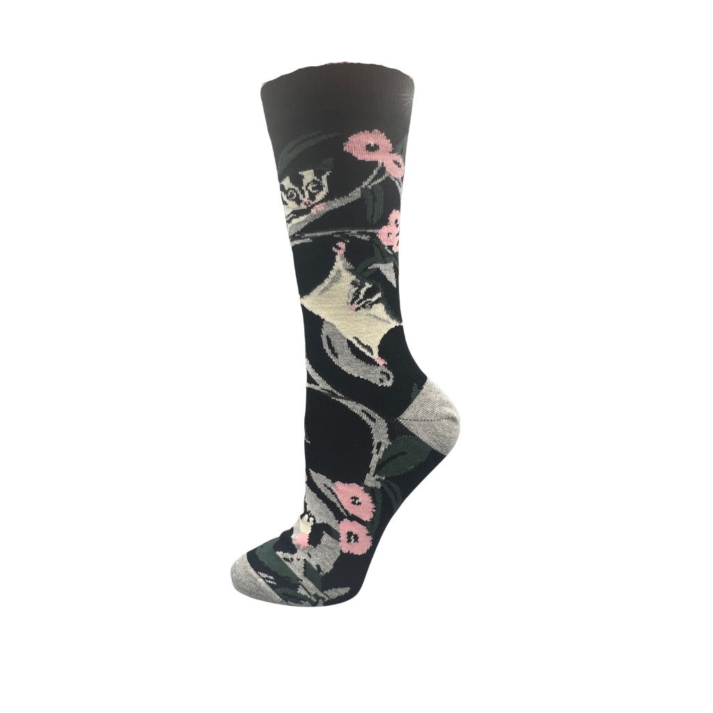 socks with possum and floral design on a black background