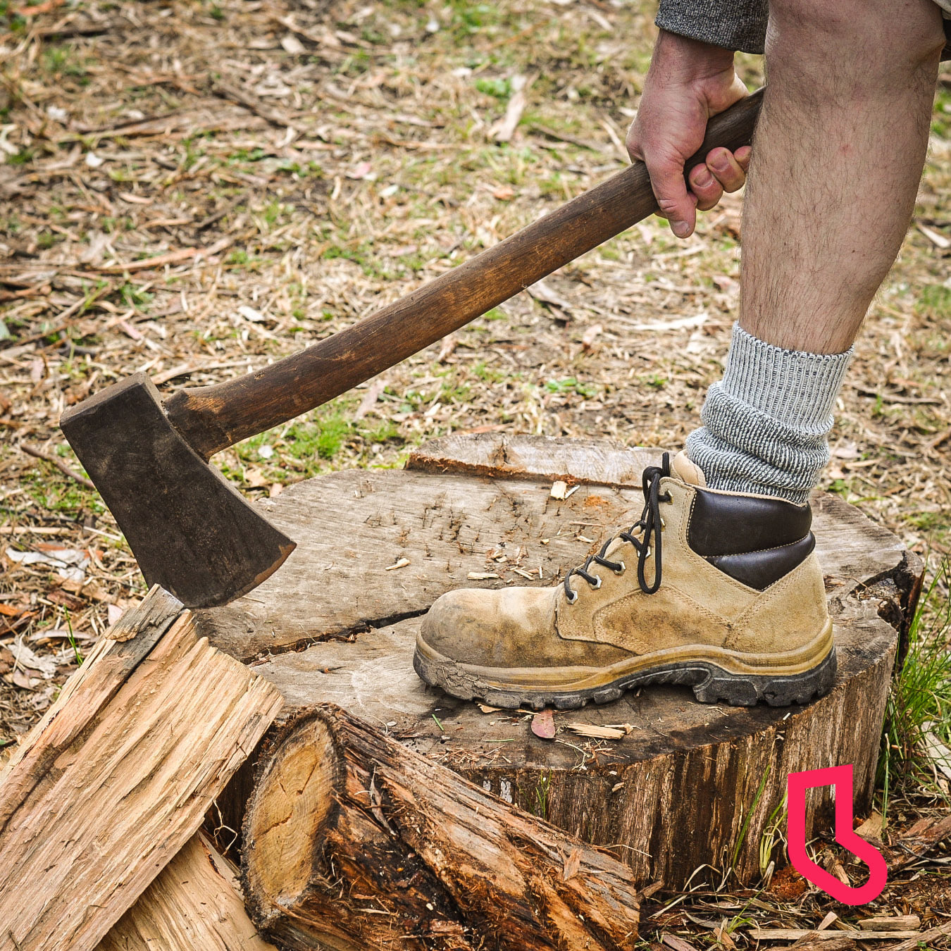 man wearing ranger boot socks chopping wood -The Sockery