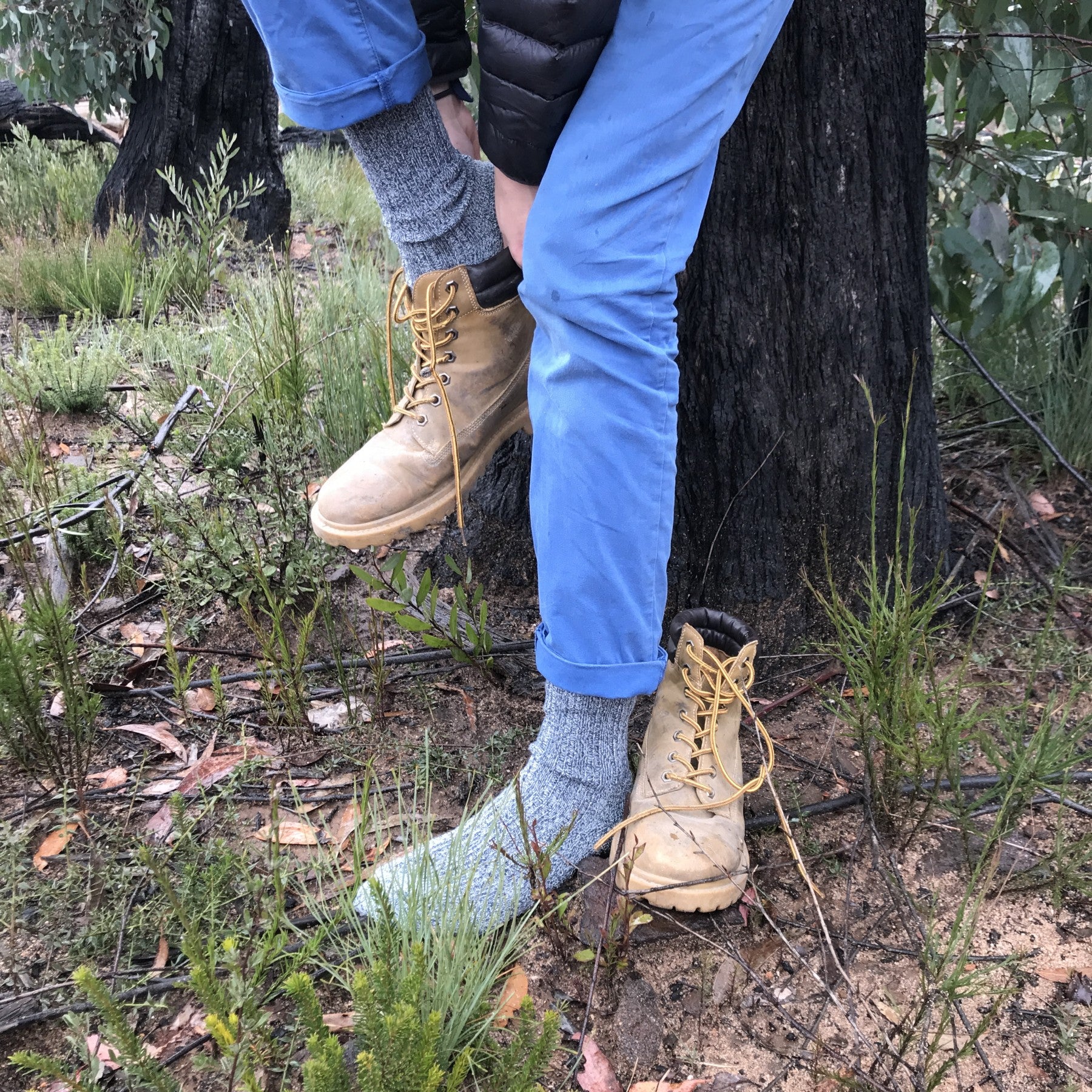 man putting on his boots wearing blue stone warm thick merino wool socks - The Sockery