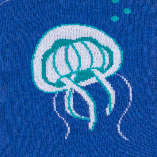 Detail of a light grey jelly fish with turquoise highlights on a blue back ground - The Sockery