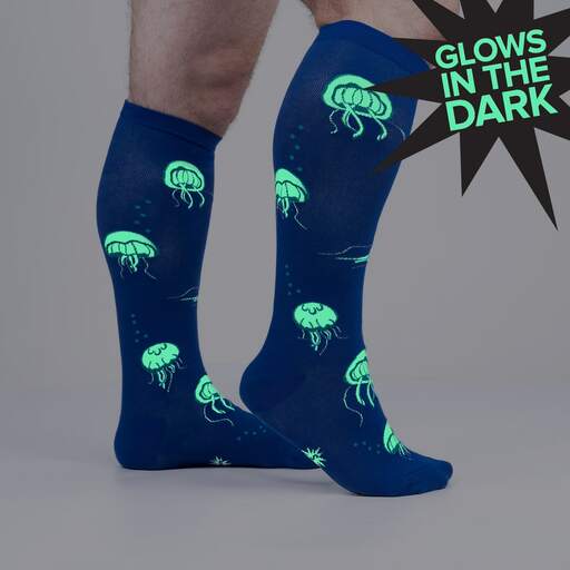Image of the socks taken in the dark. The jelly fish are glowing in green - The Sockery