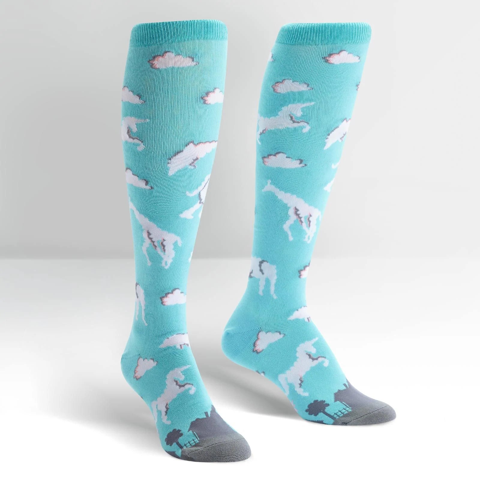 Sky blue knee high socks with a variety of animals made of clouds all over. Pink and grey high lights on the clouds. The toe of the socks depicts the silhouette of a city in grey - The Sockery