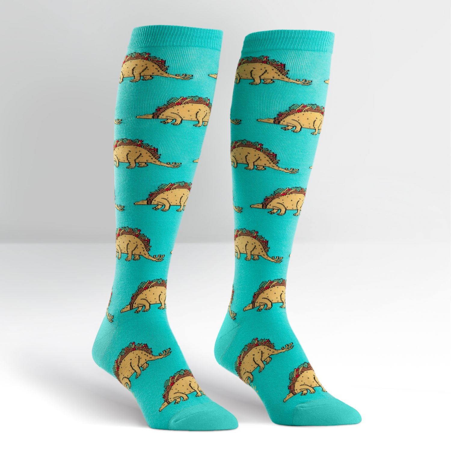 Green knee high socks with taco shells turned into dinosaurs all over- The Sockery
