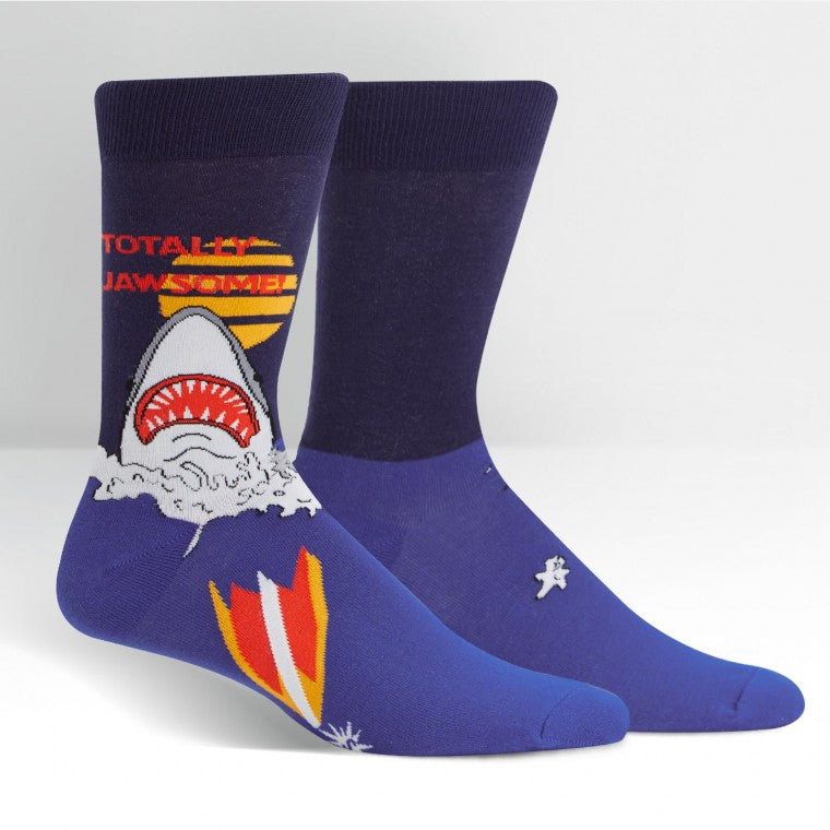 A two tone blue sock with a shark emerging from the water, featuring the words "Totally Jawsome!" - The Sockery